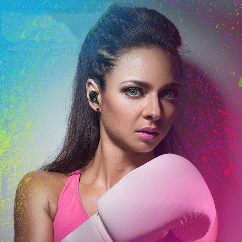 Woman wearing wireless sports headphones while boxing.