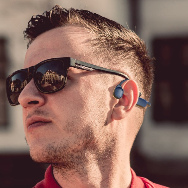 Personal Bone Conduction Bluetooth Headset worn by a man with sunglasses outdoors.