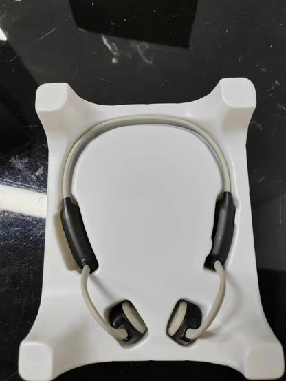 Personal bone conduction Bluetooth headset with ergonomic design in retail packaging.
